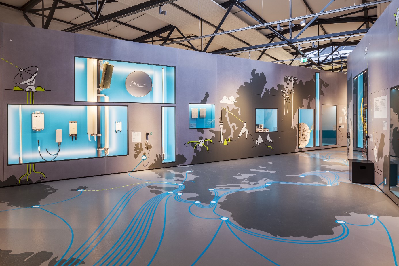 A view of the "Backbone" exhibition area, featuring a depiction of the interconnected world on the floor.