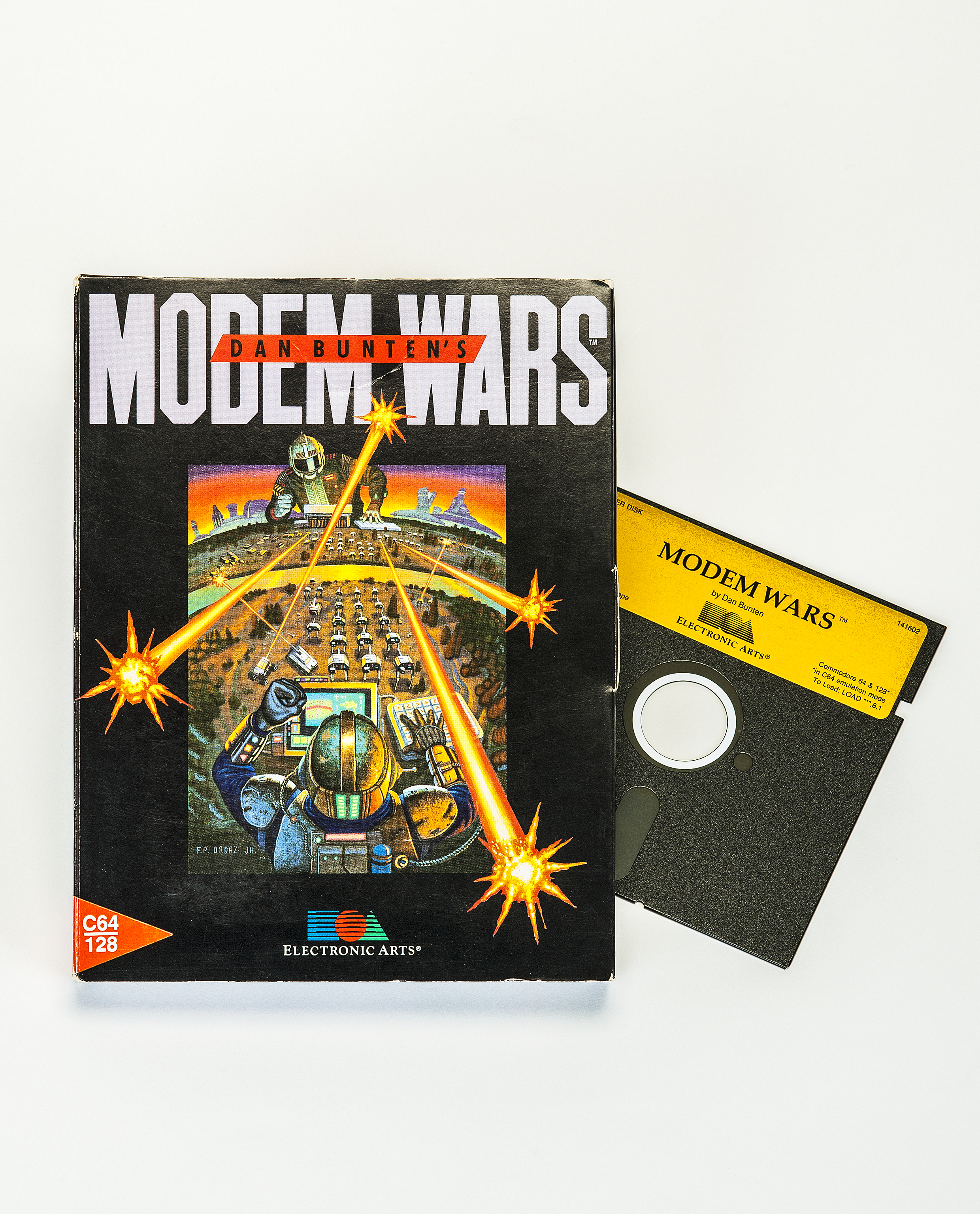 The cover of the video game *Modem Wars*. The 5-1/4-inch floppy disk containing the game is pulled out of the case on the right. The image on the cover shows two players in futuristic armor commanding tank armies via a screen and keyboards.