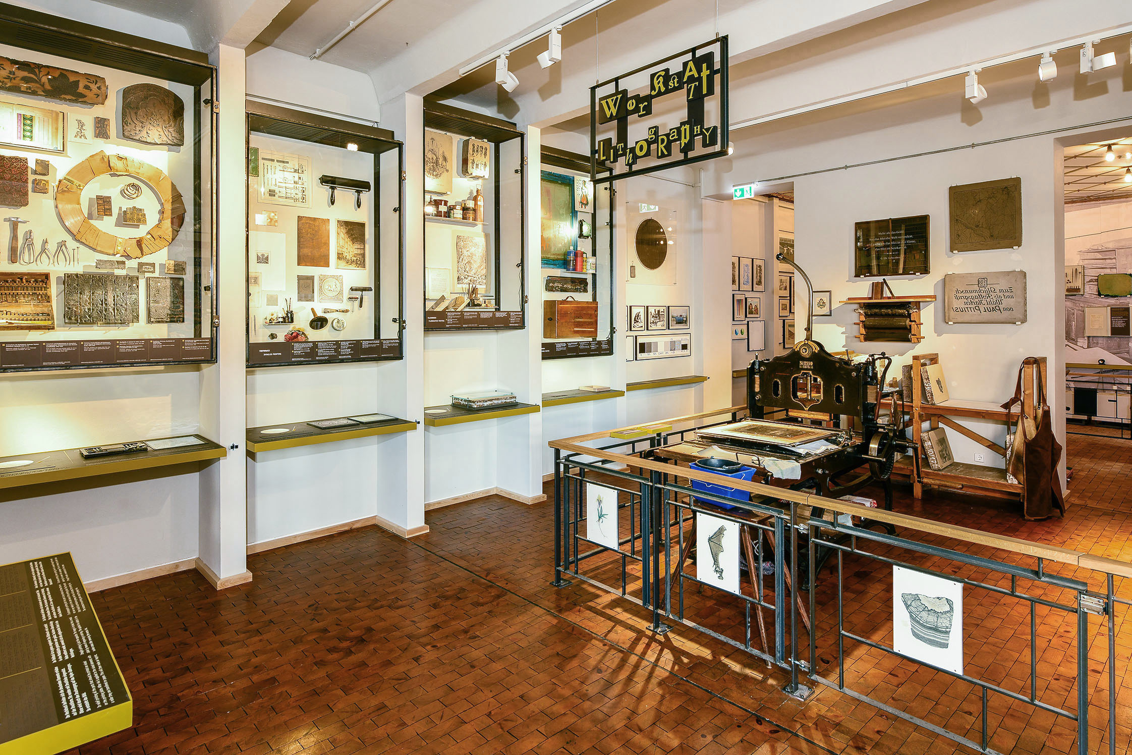 A view of a corner of the exhibition space featuring lithography tools.