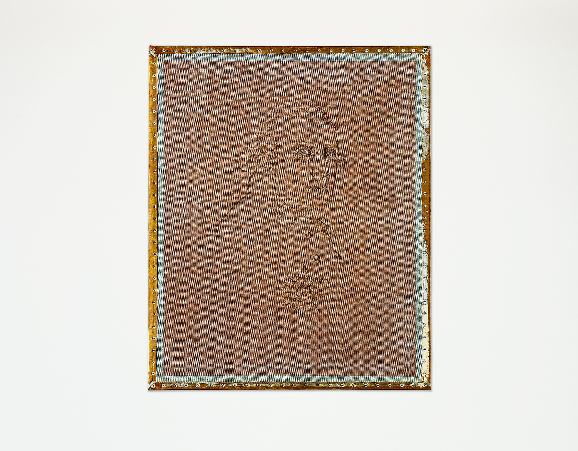 A metal strainer with a brown wooden frame, about the size of a book page. The face of Frederick the Great can be seen on it. 