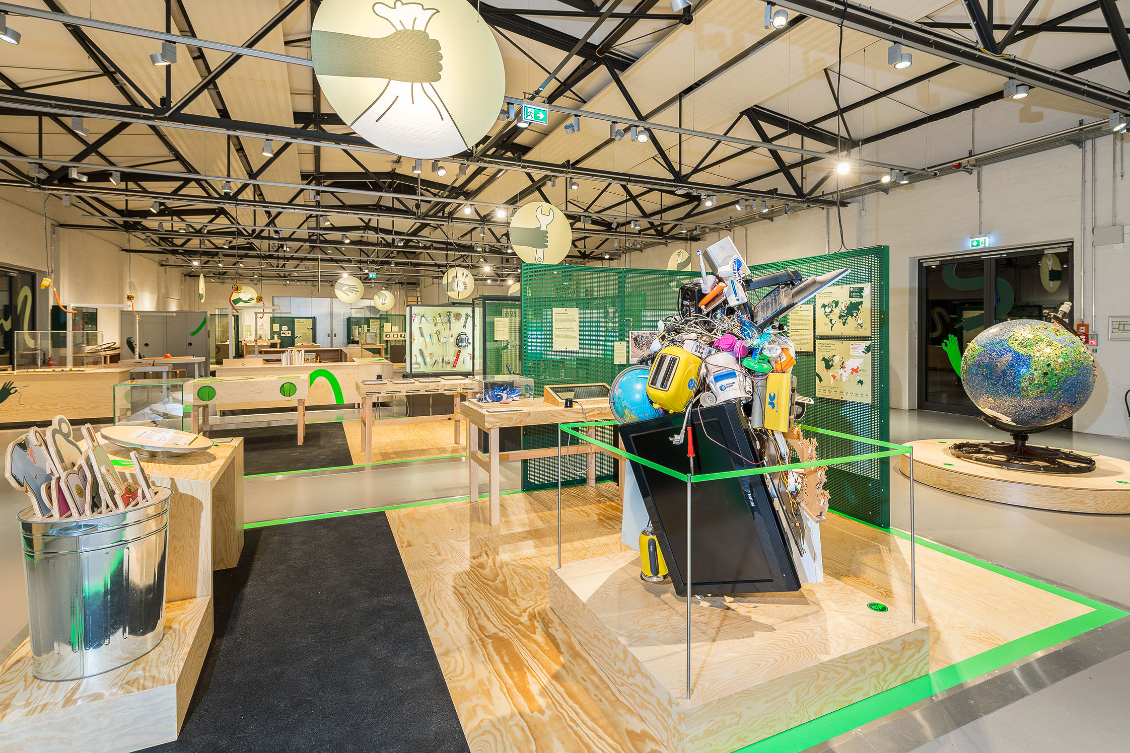 A view of the exhibition. In the foreground is a pile of electronic waste.
